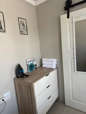 a bathroom with a dresser and a mirror at The Pool_deck apartment in Lebowakgomo