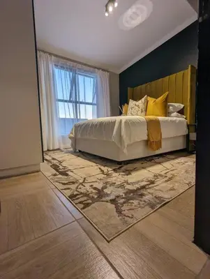 a bedroom with a large bed and a window at Spacious 2 Bedroom Apartment in Midrand, Waterfall City - Business and Family friendly - 1 Elizabeth Place in Midrand