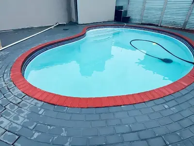 a large swimming pool with a red line around it at Mudix Royal Palace Guest Lodge in Musina