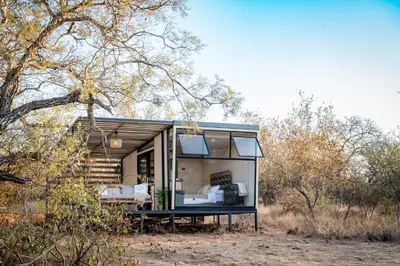a tiny house in the middle of a field at Kamoka Camp in Hoedspruit