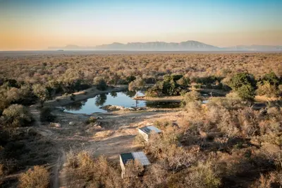 an aerial view of a river in a field at Kamoka Camp in Hoedspruit