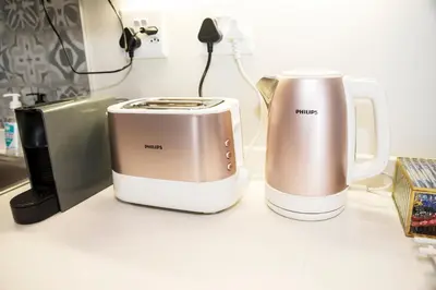 two toasters sitting on a counter next to a toaster at Eirini Elegant - Artemis Apartment Carlswald in Midrand