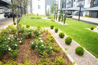 a garden with flowers and bushes in a yard at Eirini Elegant - Artemis Apartment Carlswald in Midrand