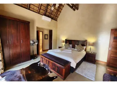 a bedroom with a large bed in a room at Zebula Bush Lodge 118 in Mabula