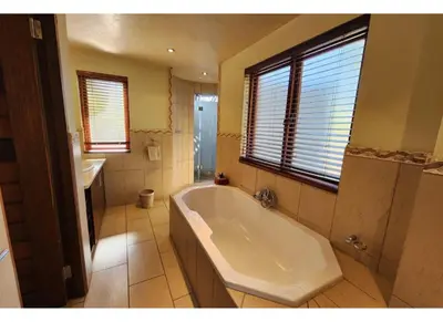a large bathroom with a tub and a sink at Zebula Bush Lodge 118 in Mabula
