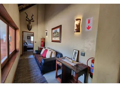 a living room with a couch and a table at Zebula Bush Lodge 118 in Mabula