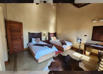 a bedroom with two beds and a desk at Zebula Bush Lodge 118 in Mabula