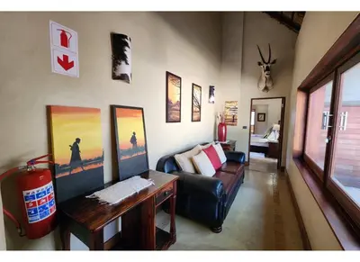 a living room with a couch and a table at Zebula Bush Lodge 118 in Mabula