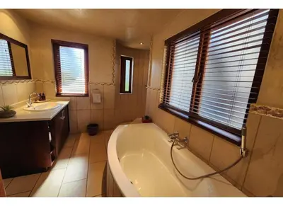a bathroom with a bath tub and a sink at Zebula Bush Lodge 118 in Mabula