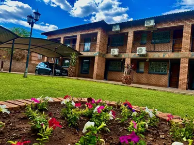 a garden in front of a building with flowers at Valozone70 Guesthouse in Thabazimbi