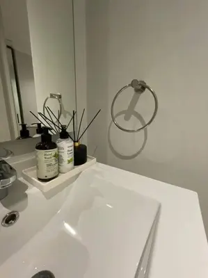 a bathroom with a white sink and a mirror at Ellipse Waterfall luxurious unit in Midrand