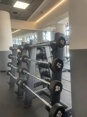 a gym with rows of dumbbells at Ellipse Waterfall luxurious unit in Midrand