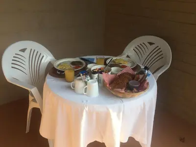 a table with a basket of food on it at Oppi Plaas in Hazyview