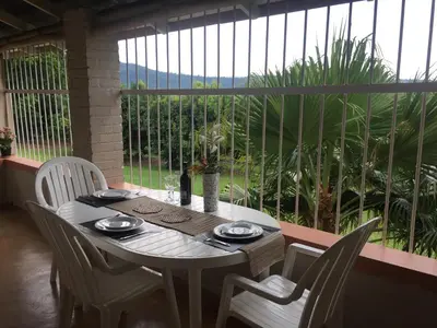 a white table with white chairs on a patio at Oppi Plaas in Hazyview