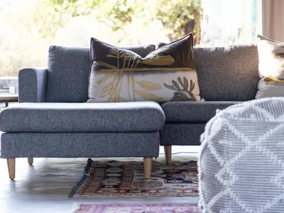 a living room with a couch and a chair at Lavish villa in Hoedspruit with hot tub in Hoedspruit