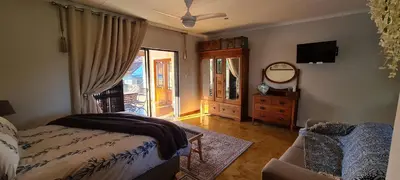 a bedroom with a bed and a dresser and a window at Upstairs R-2 Self-Catering Unit in White River
