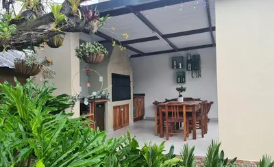 a kitchen and dining room with a table and chairs at Upstairs R-2 Self-Catering Unit in White River