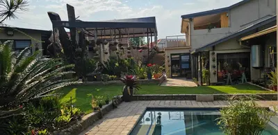 a house with a swimming pool in a yard at Upstairs R-2 Self-Catering Unit in White River