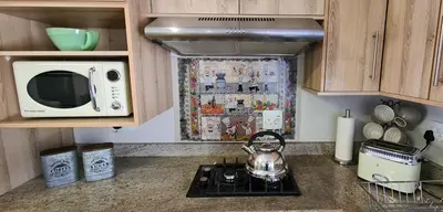 a kitchen counter with a tea kettle on a stove at Upstairs R-2 Self-Catering Unit in White River