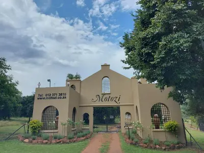 a building with a sign on the front of it at Motozi Lodge in Pelindaba