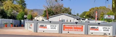 a building with signs on the side of a street at Sleep 'n Go Guesthouse in Mokopane