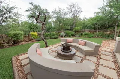 a patio with a bench and a fire pit at Nyaleti Lodge in Hoedspruit