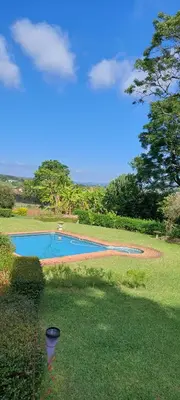 a view of two swimming pools in a yard at Bannockburn Guest Cottage in White River