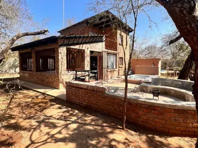a small brick house with a brick wall at Bundu in Marloth Park