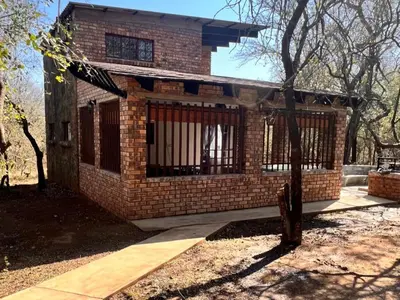 a brick house with bars on the front of it at Bundu in Marloth Park