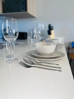 a table with a plate and a glass of wine at Dubai 2 in Midrand