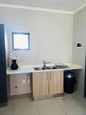 a kitchen with a sink and a counter at Dubai 2 in Midrand