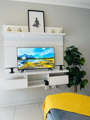 a living room with a tv on a white wall at Dubai 2 in Midrand