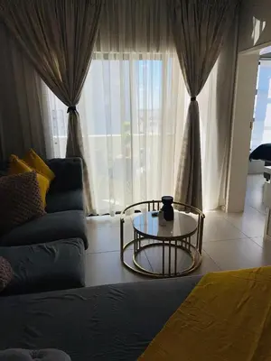 a living room with a coffee table in front of a window at Dubai in Midrand