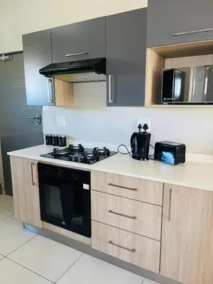 a kitchen with a stove and a microwave at Dubai in Midrand