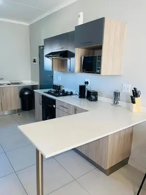 a kitchen with a white counter top in a room at Dubai in Midrand