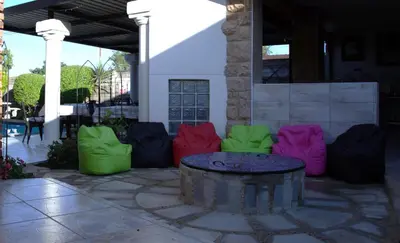 a group of colorful chairs sitting around a table at Xaviera Guest House in Pretoria