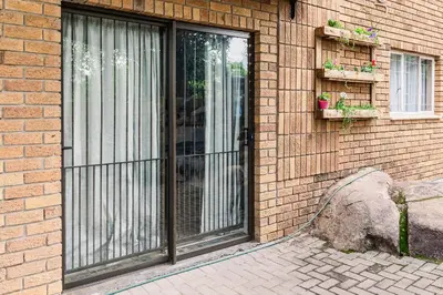 a glass door on the side of a brick building at Stamvrug 9 B in Nelspruit