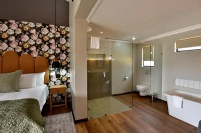 a bedroom with a bed and a shower and a bathroom at Dunkeld East in Dullstroom