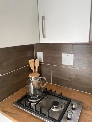 a kitchen stove with a glass jar on top of it at Spacious stay-in bachelor apartment in Kempton Park