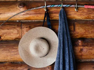 a straw hat and two ties hanging on a wall at Mountain Canadian Log Home in Kalkheuvel