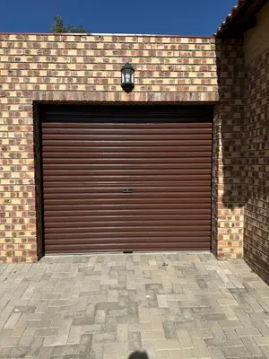 a brown garage door with a light on top at Lloyds - unit 10 in Ermelo