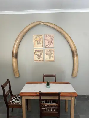 a table with two chairs and an arch above it at Lloyds - unit 10 in Ermelo