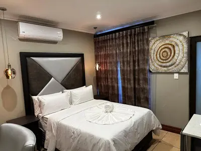 a bedroom with a white bed and a window at Urban Villas Guest House in Pretoria