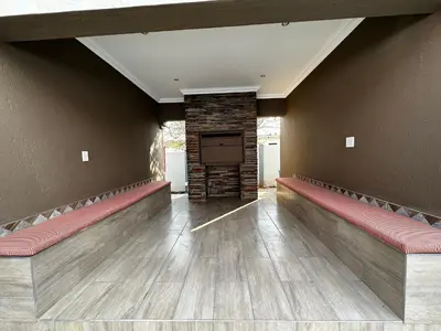 a waiting room with benches and a flat screen tv at Urban Villas Guest House in Pretoria