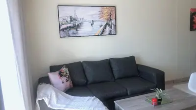 a living room with a couch and a picture on the wall at Menlyn Place Staycation in Pretoria