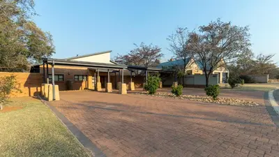 a brick driveway in front of a building at Euphoria Golfers letting House 405 Euphoria golf and life style estate in Naboomspruit