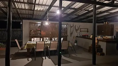 a dining room with a table and chairs at Hambana Lifestyle Lodge in Musina