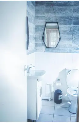 a bathroom with a sink and a toilet and a mirror at 19 @ Pendleberry in Bela-Bela