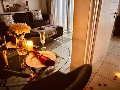 a living room with a glass table with a candle at The Blyde Luxury Retreat in Pretoria
