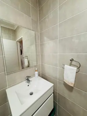 a bathroom with a white sink and a mirror at The Blyde Luxury Retreat in Pretoria